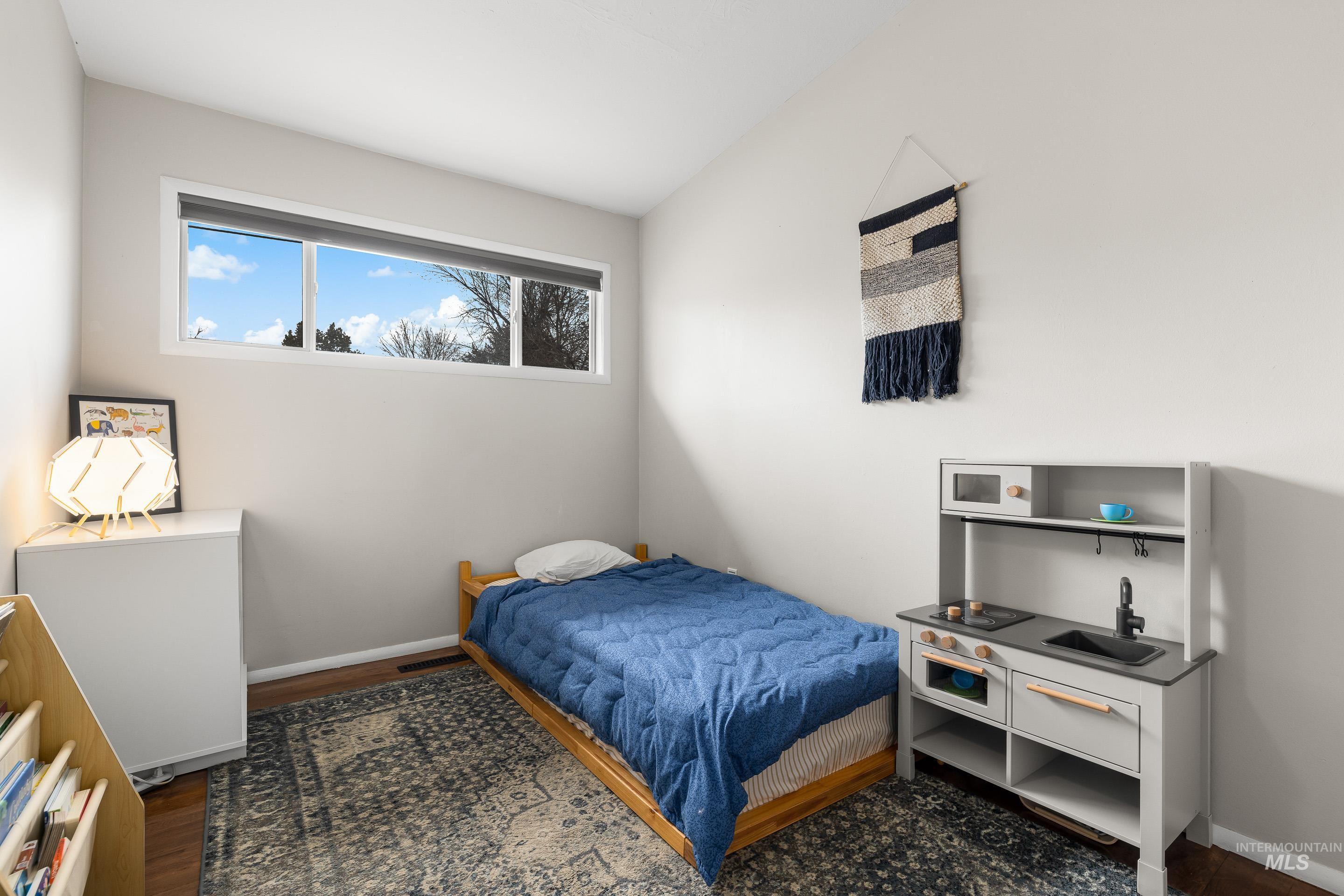 2824 West Kathryn Street Boise, ID 83705 - Photo 33 of 40 Bedroom with vaulted ceiling and dark wood finished floors