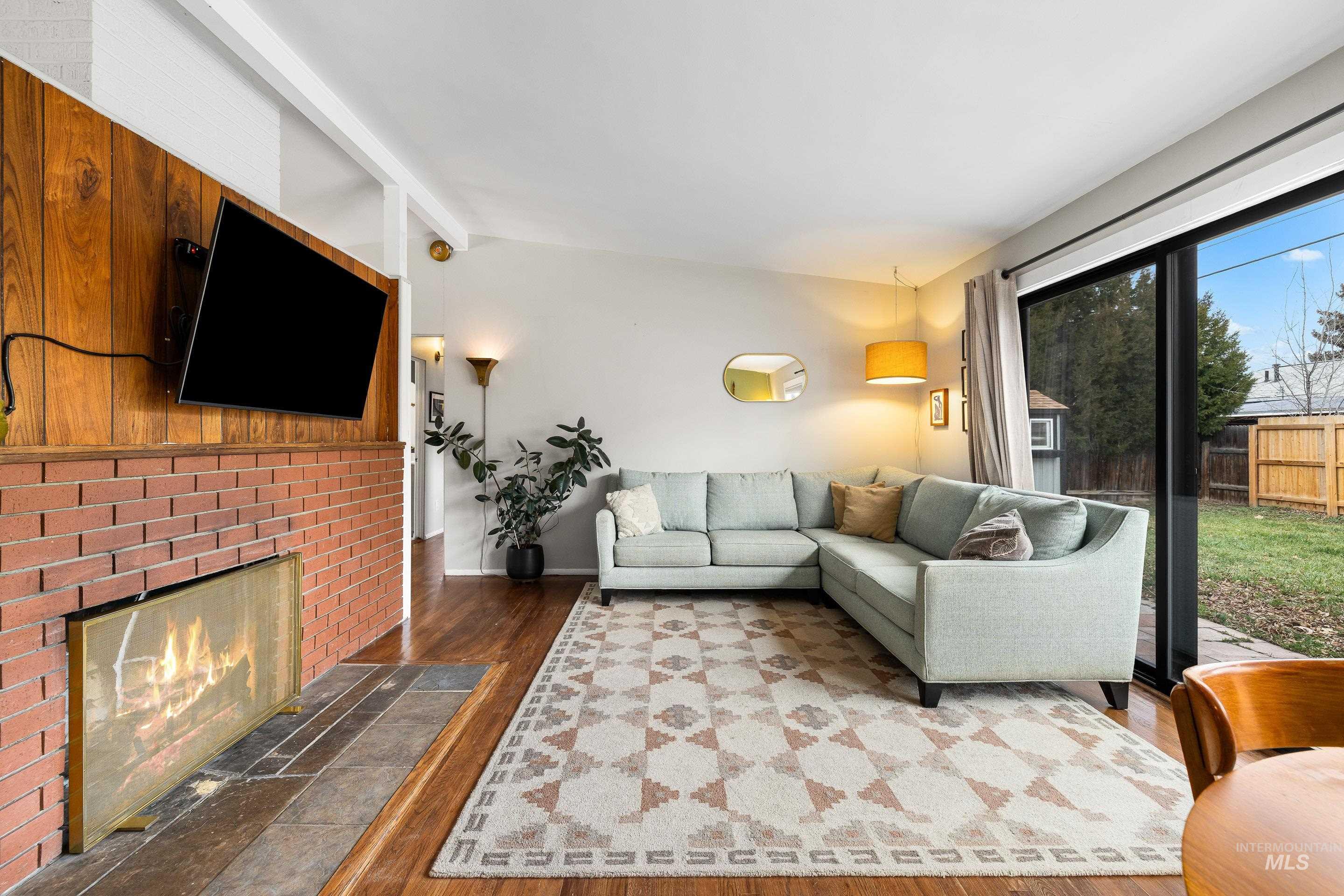 2824 West Kathryn Street Boise, ID 83705 - Photo 8 of 40 Living area featuring wood finished floors and a brick fireplace