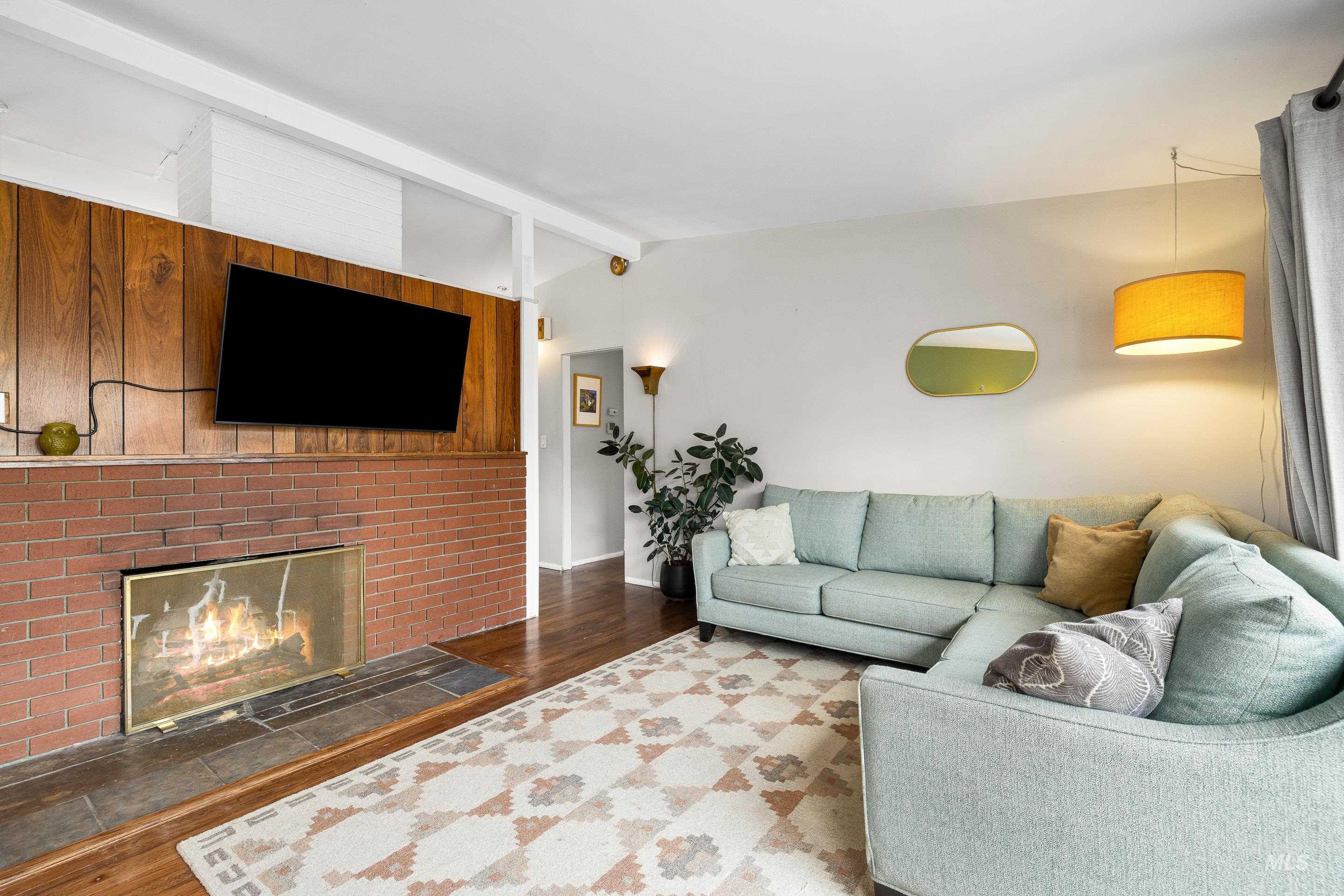 2824 West Kathryn Street Boise, ID 83705 - Photo 9 of 40 Living area featuring a fireplace and dark wood finished floors