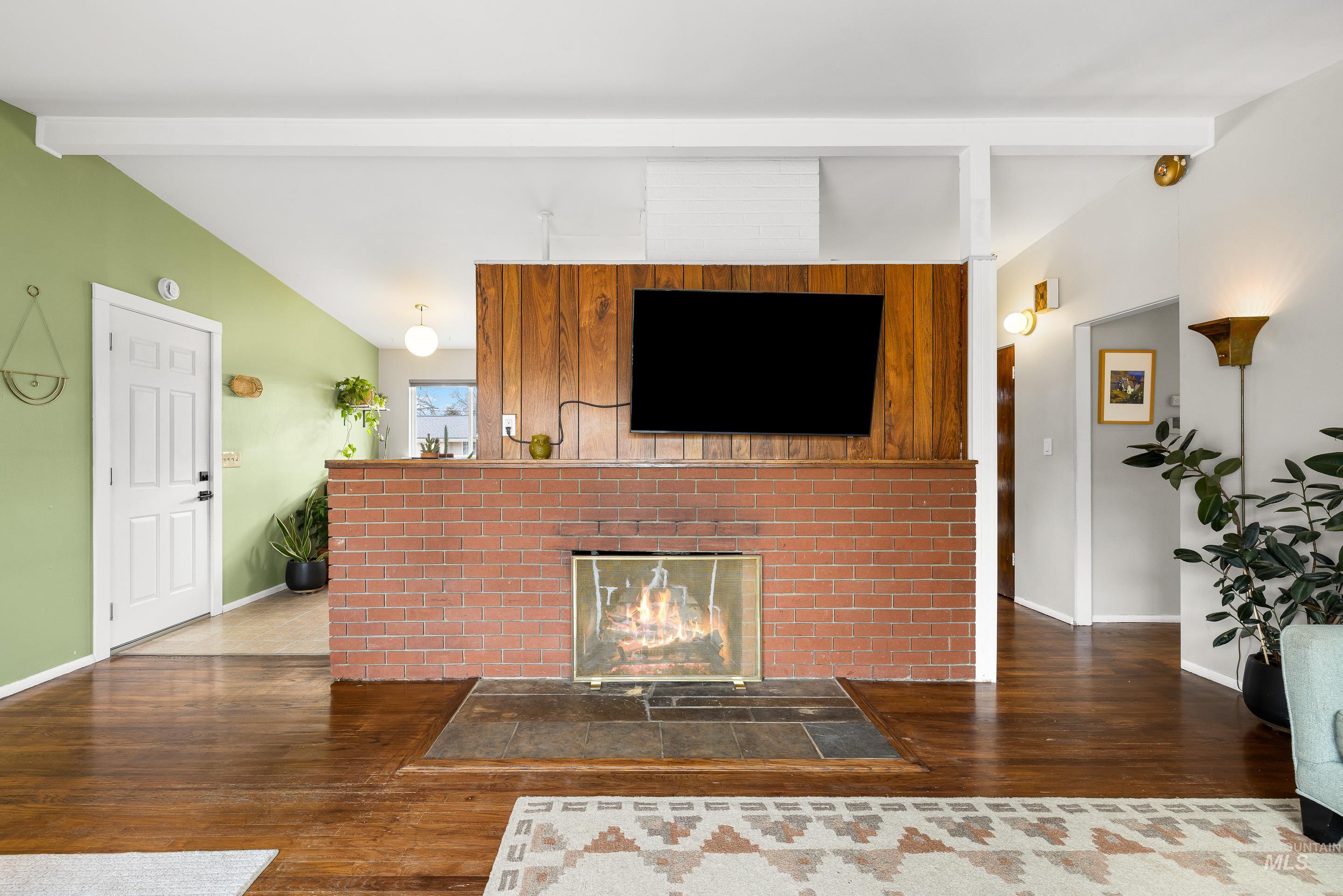 2824 West Kathryn Street Boise, ID 83705 - Photo 10 of 40 Living area featuring dark wood finished floors and a fireplace