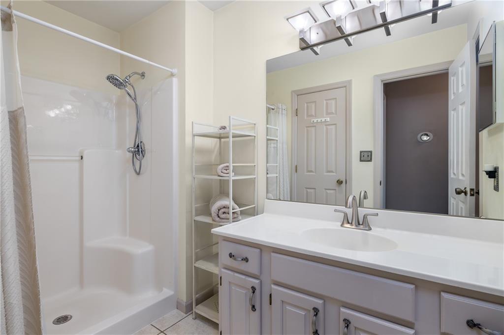 45 Spring Valley Drive Washington, PA 15301 - Photo 14 of 26 a bathroom with a shower sink vanity and mirror