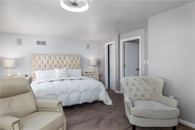 a bedroom with a bed and a couch