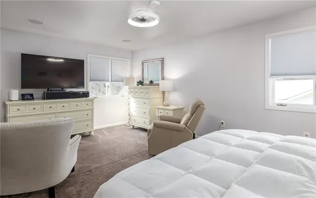 a bedroom with furniture and a flat screen tv