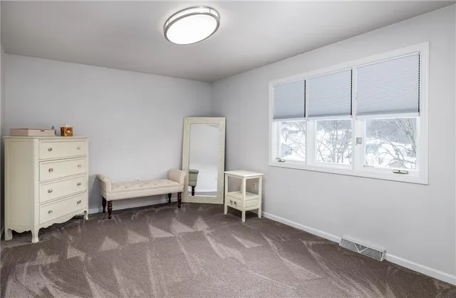 a view of a bedroom with furniture and windows