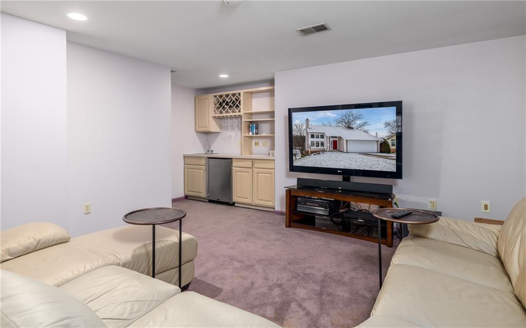 45 Spring Valley Drive Washington, PA 15301 - Photo 22 of 26 a living room with furniture and a flat screen tv