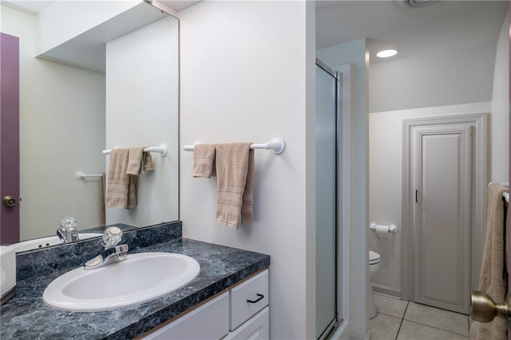 45 Spring Valley Drive Washington, PA 15301 - Photo 23 of 26 a bathroom with a granite countertop sink and a mirror