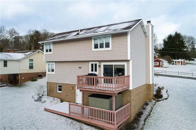 a front view of a house with balcony and furniture