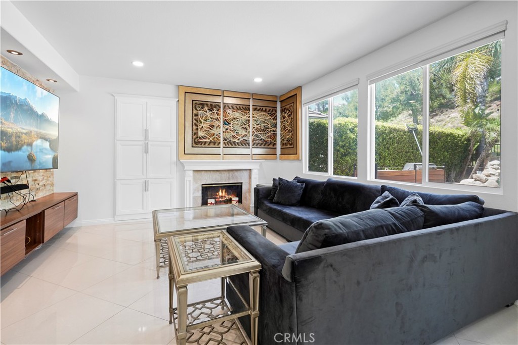 20621 Pesaro Way Porter Ranch, CA 91326 - Photo 17 of 45 a living room with furniture and a fireplace