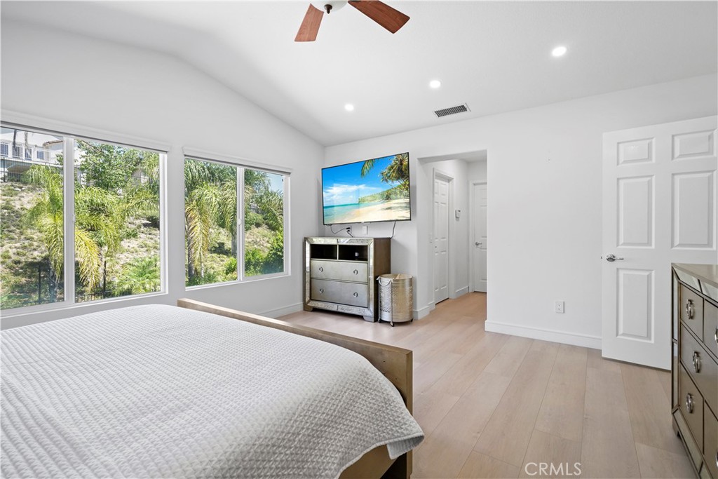 20621 Pesaro Way Porter Ranch, CA 91326 - Photo 22 of 45 a spacious bedroom with a bed and a television