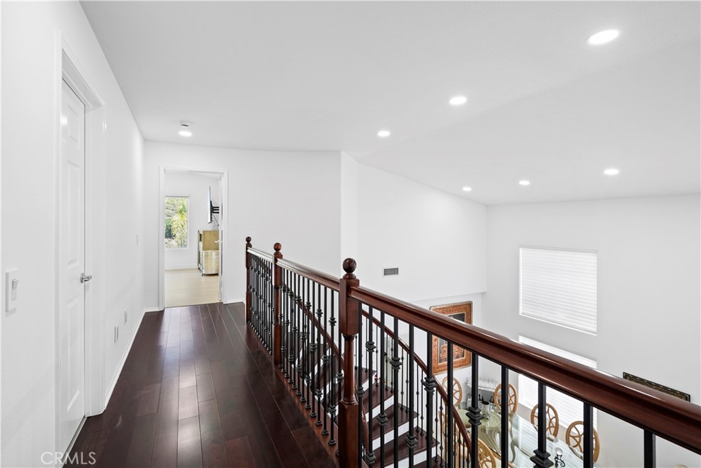 20621 Pesaro Way Porter Ranch, CA 91326 - Photo 23 of 45 a view of a hallway with wooden floor and stairs