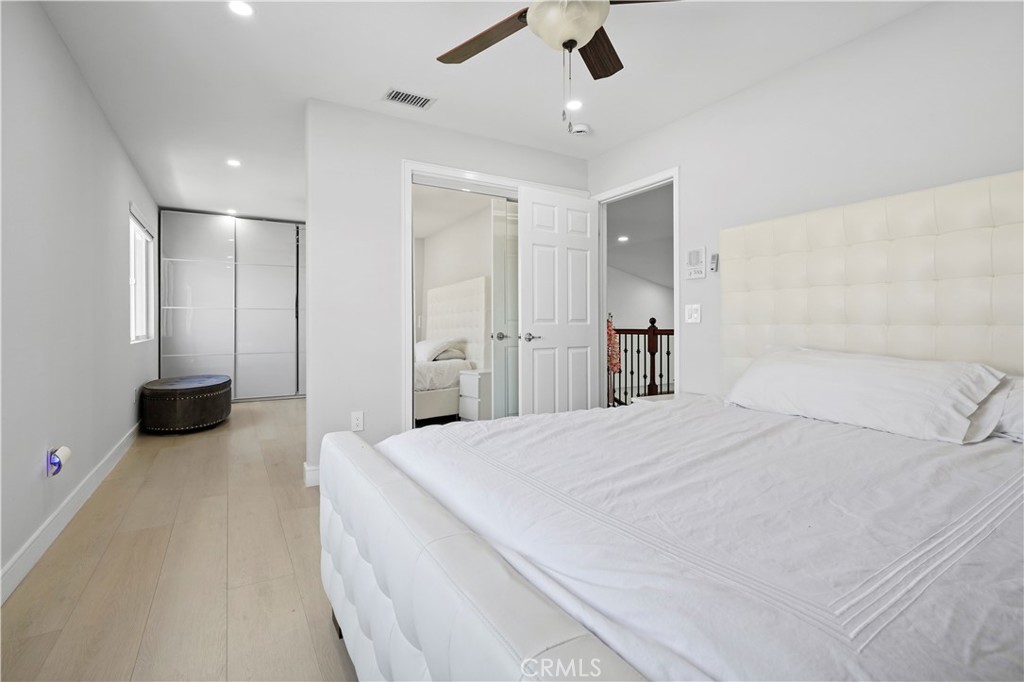 20621 Pesaro Way Porter Ranch, CA 91326 - Photo 29 of 45 a spacious bedroom with a bed and a chandelier