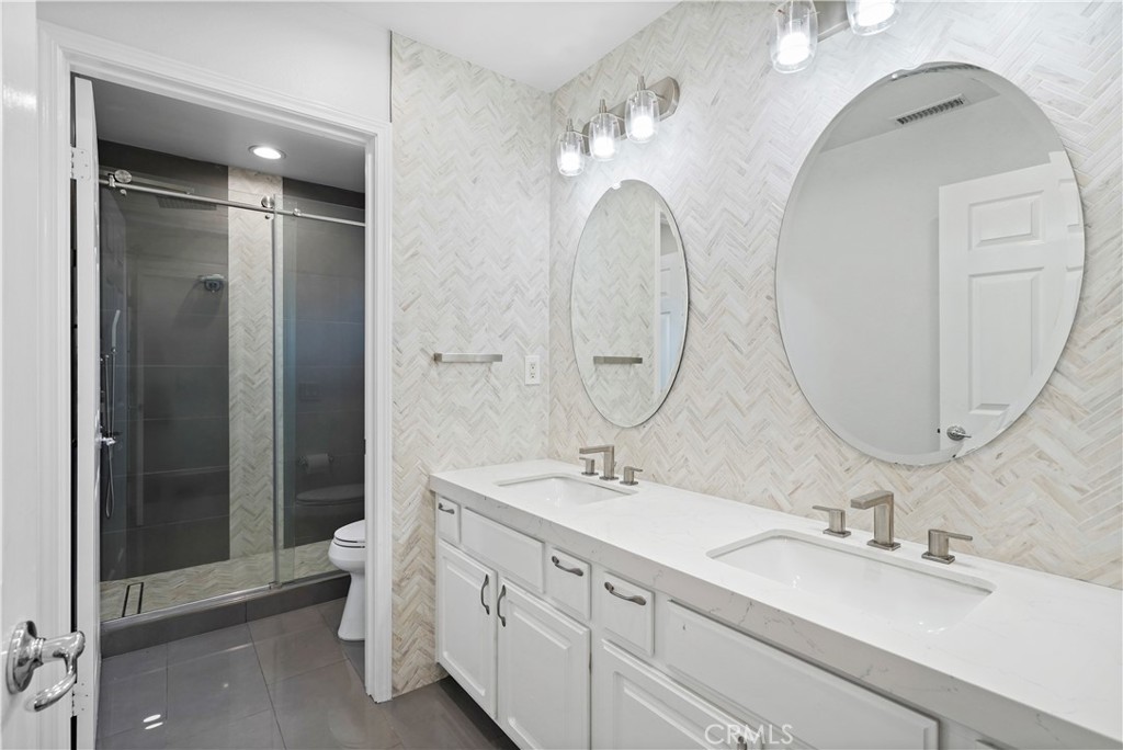20621 Pesaro Way Porter Ranch, CA 91326 - Photo 32 of 45 a bathroom with a double vanity sink mirror and shower