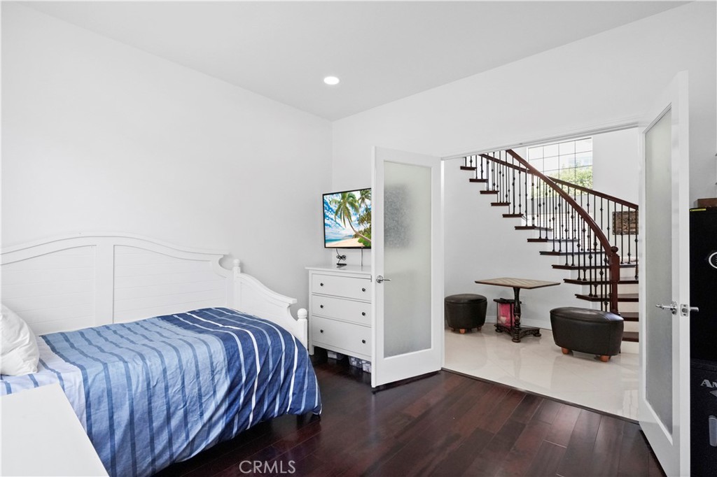 20621 Pesaro Way Porter Ranch, CA 91326 - Photo 34 of 45 a bedroom with a bed and wooden floor