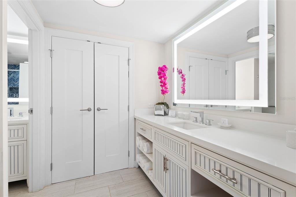240 Sands Point Road, Unit 4104 Longboat Key, FL 34228 - Photo 17 of 47 a bathroom with a sink and a mirror