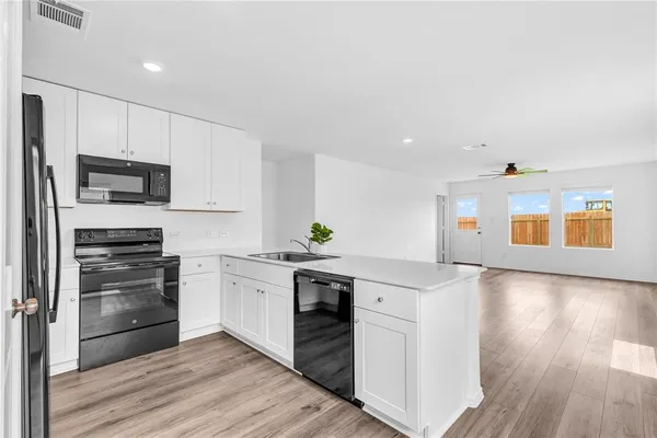 a kitchen with stainless steel appliances granite countertop a stove and a refrigerator
