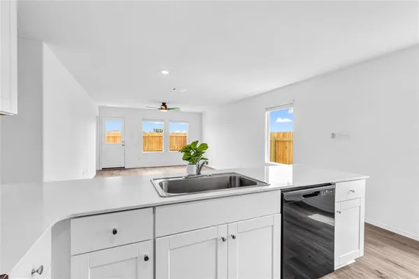 a kitchen with stainless steel appliances a sink stove and cabinets