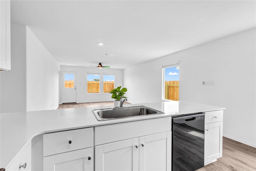 516 Rancho Del Cielo Loop Jarrell, TX 76537 - Photo 17 of 33 a kitchen with stainless steel appliances a sink stove and cabinets
