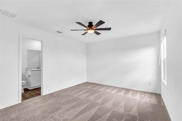 a view of a room with a ceiling fan and a hardwood floor