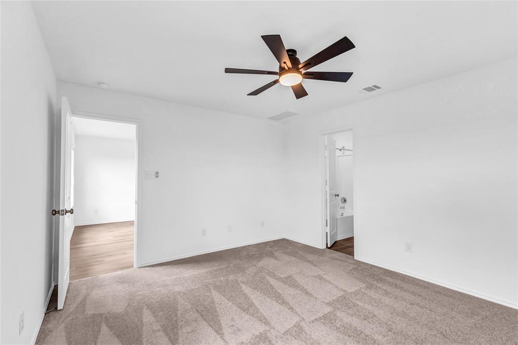516 Rancho Del Cielo Loop Jarrell, TX 76537 - Photo 20 of 33 a view of a big room with wooden floor and closet