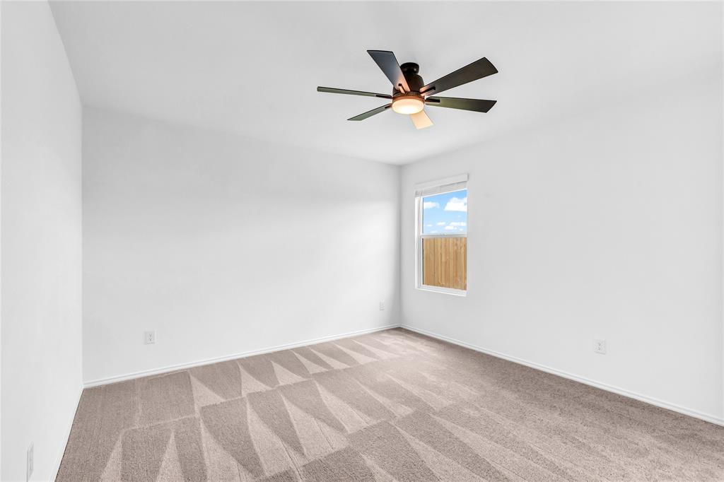 516 Rancho Del Cielo Loop Jarrell, TX 76537 - Photo 21 of 33 a view of a big room with wooden floor and windows