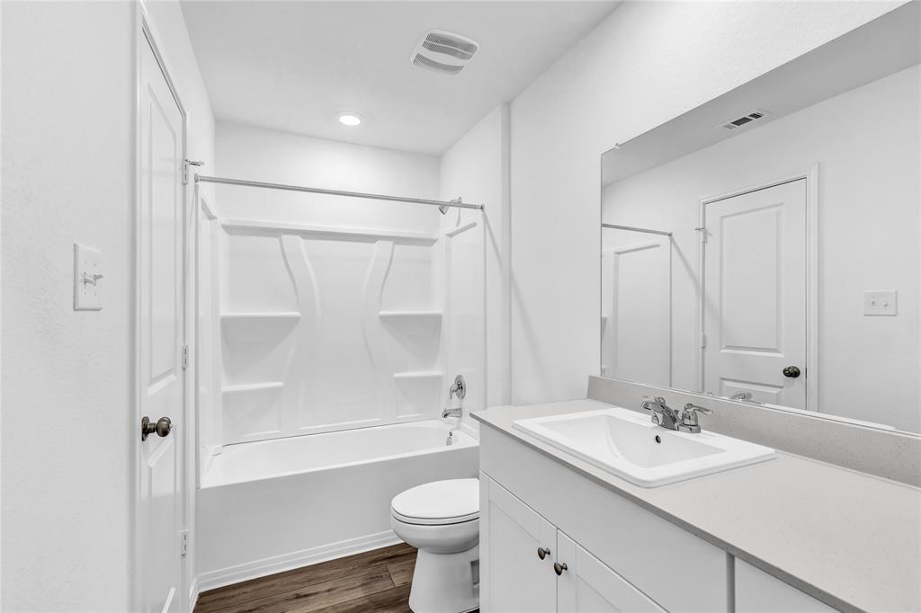 516 Rancho Del Cielo Loop Jarrell, TX 76537 - Photo 23 of 33 a bathroom with a sink a toilet and shower