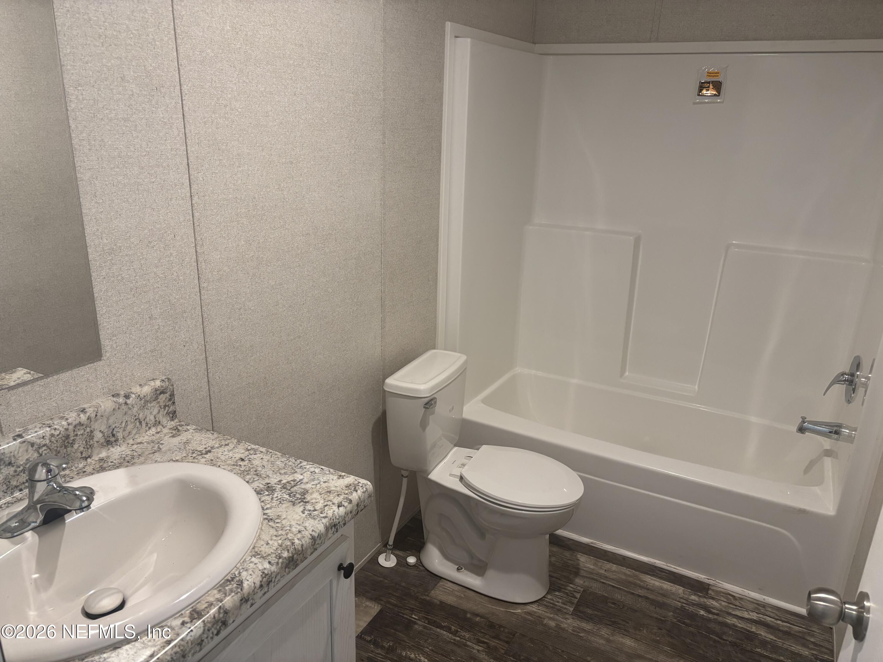 1726 Bermuda Road Jacksonville, FL 32224 - Photo 4 of 5 a bathroom with a granite countertop sink toilet and a bathtub