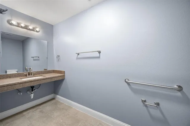 a room with a sink and a mirror