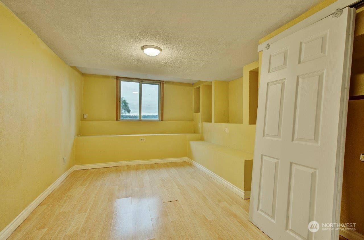 3906 South Pilgrim Street Seattle, WA 98118 - Photo 11 of 29 a view of a room with wooden floor and a bathroom
