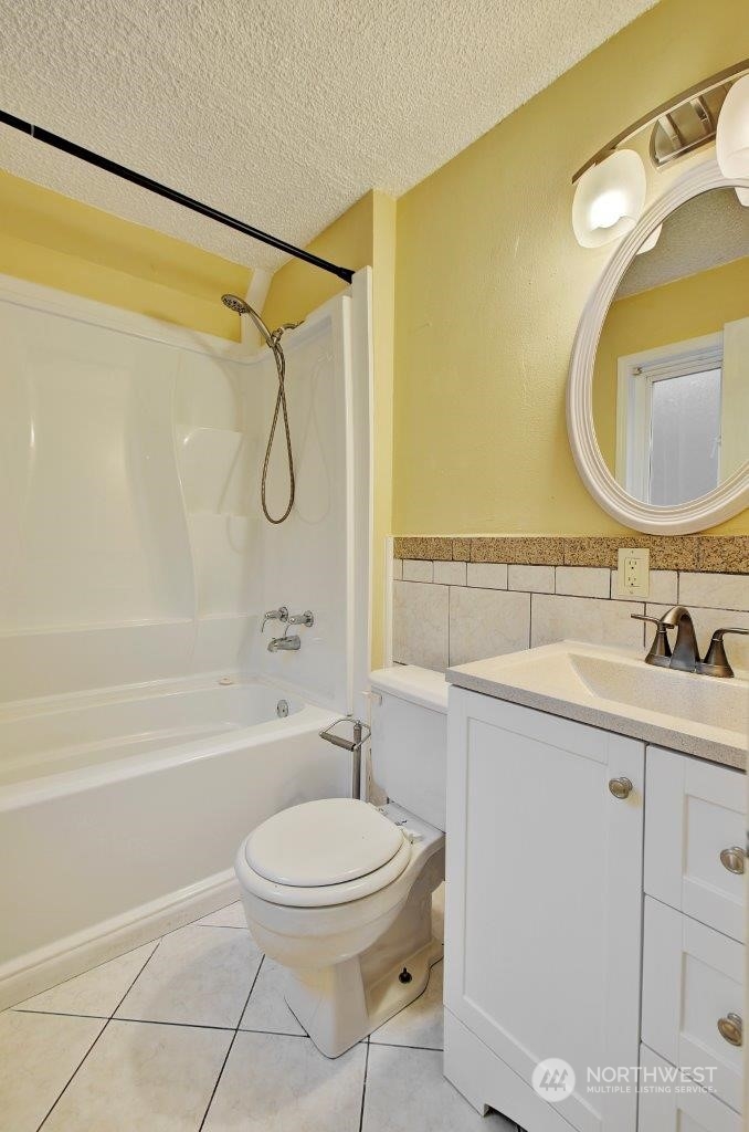 3906 South Pilgrim Street Seattle, WA 98118 - Photo 21 of 29 a bathroom with a sink a toilet and shower