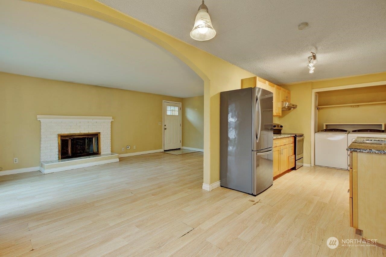 3906 South Pilgrim Street Seattle, WA 98118 - Photo 3 of 29 a view of a kitchen with a sink cabinets and a refrigerator