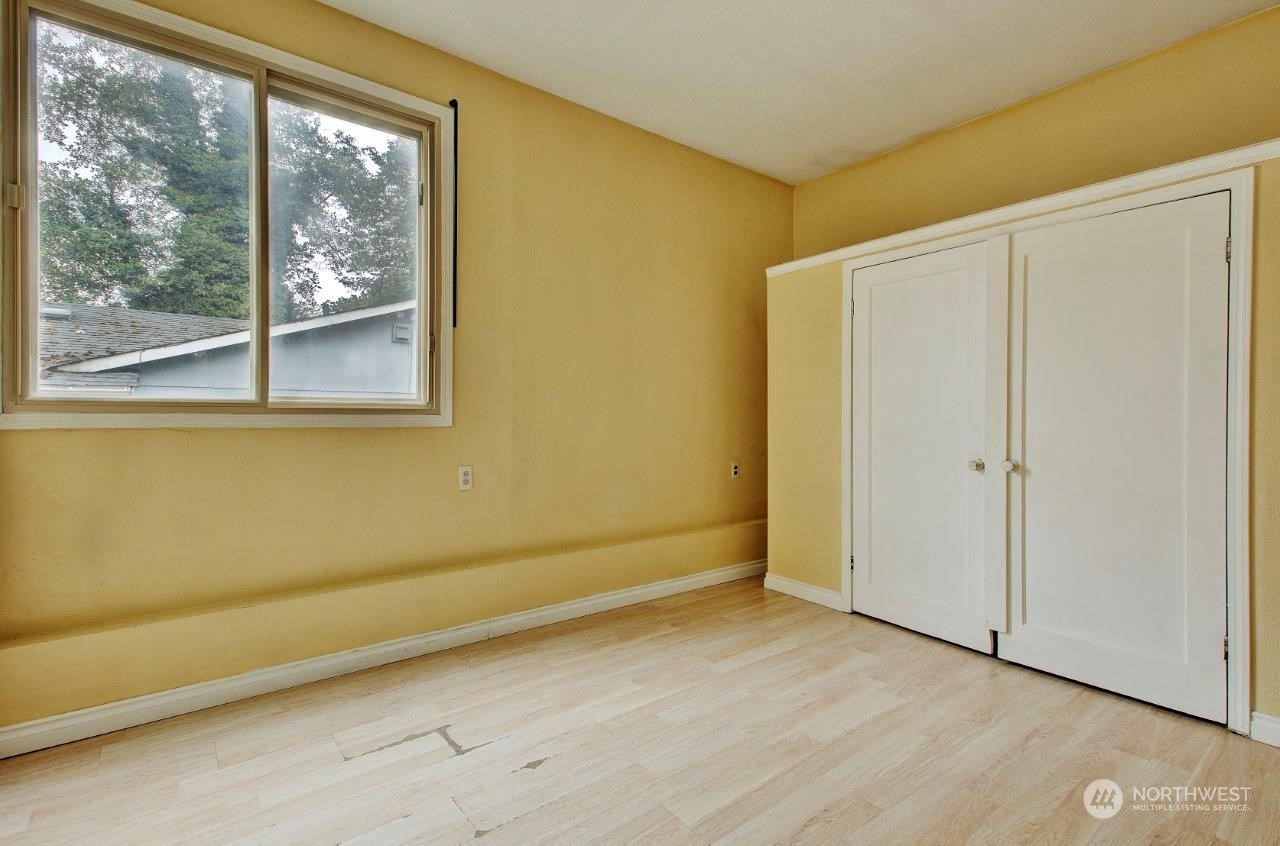 3906 South Pilgrim Street Seattle, WA 98118 - Photo 10 of 29 a view of a room with wooden floor and doors