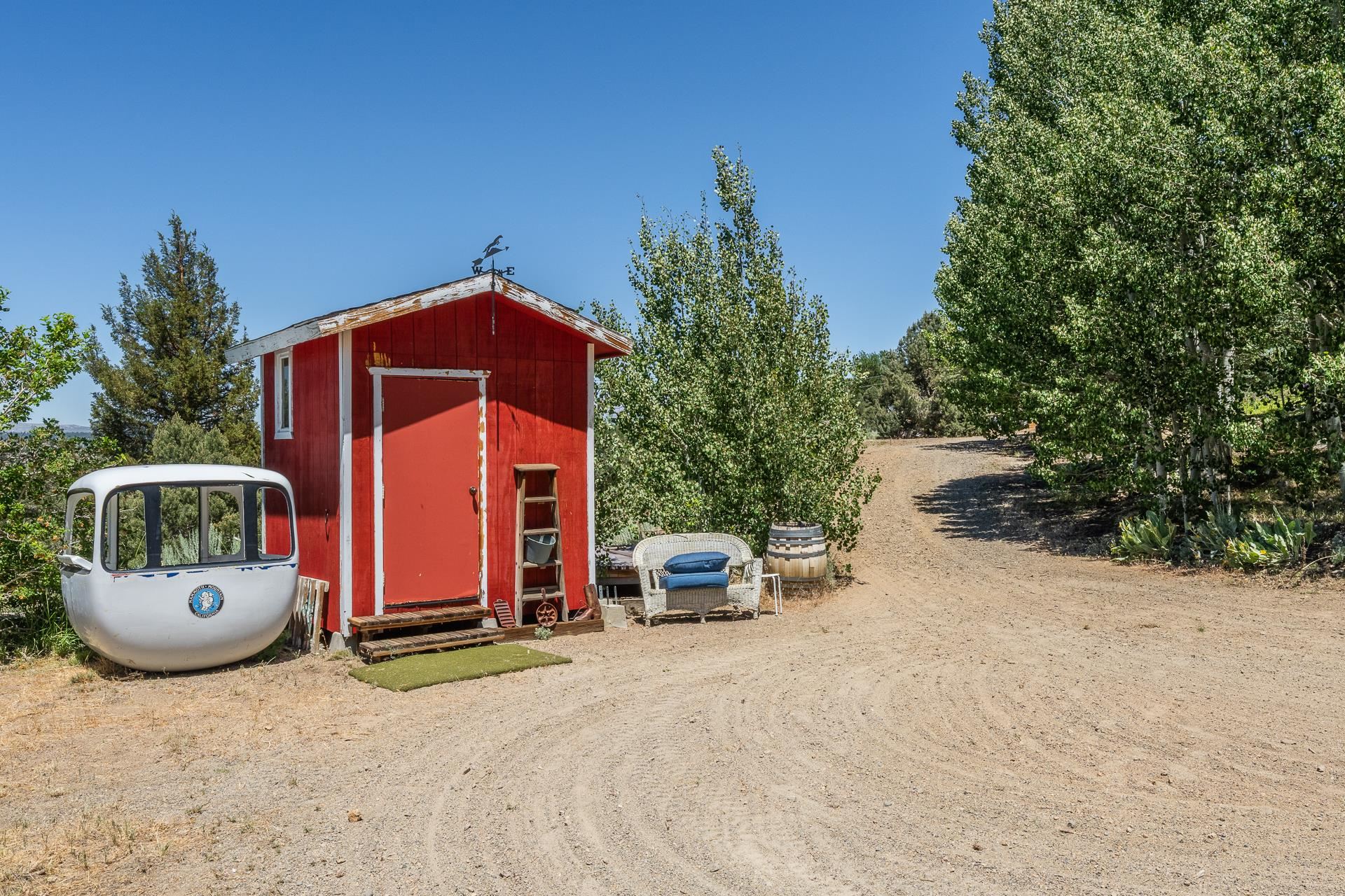 537 Aspen Spring Ranch Road Mammoth Lakes, CA 93546 - Photo 32 of 40 Red storage shed with a white-framed window and a weather vane on the roof