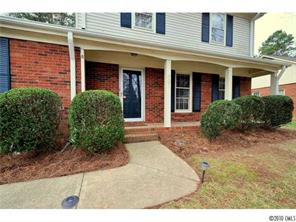 601 Trail Ridge Road Matthews, NC 28105 - Photo 2 of 16 front view of a brick house with potted plants