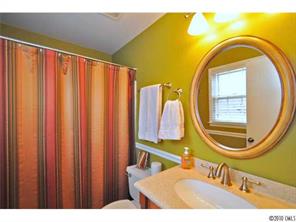 601 Trail Ridge Road Matthews, NC 28105 - Photo 13 of 16 a bathroom with a sink a mirror and a bathtub