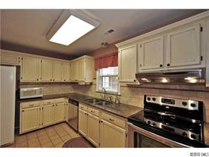 601 Trail Ridge Road Matthews, NC 28105 - Photo 5 of 16 a kitchen with stainless steel appliances granite countertop a sink stove and cabinets