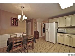 601 Trail Ridge Road Matthews, NC 28105 - Photo 6 of 16 a kitchen with refrigerator and cabinets