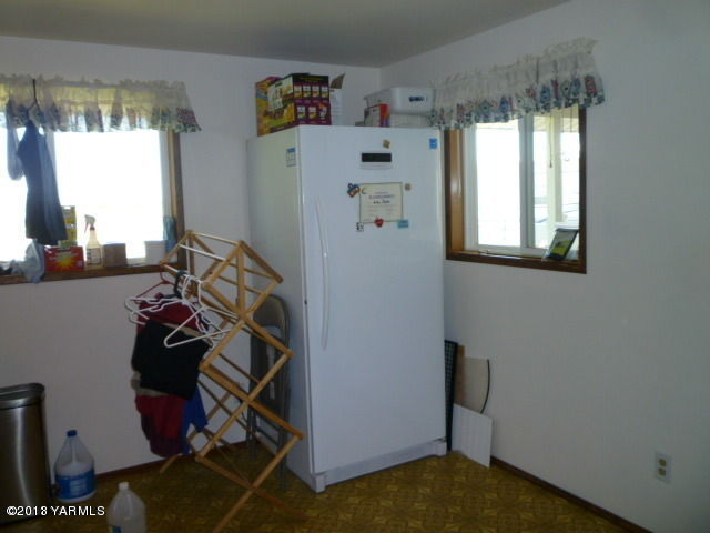 1330 Branch Road Toppenish, WA 98948 - Photo 12 of 22 a view of a kitchen with fridge and workspace