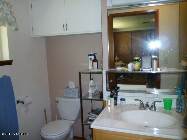 1330 Branch Road Toppenish, WA 98948 - Photo 16 of 22 a bathroom with a toilet sink and mirror