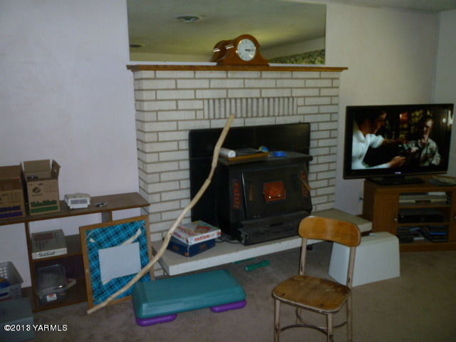 1330 Branch Road Toppenish, WA 98948 - Photo 22 of 22 a living room with furniture a flat screen tv and a fireplace