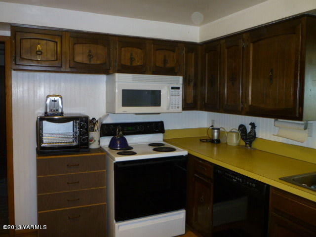 1330 Branch Road Toppenish, WA 98948 - Photo 8 of 22 a kitchen with a sink and a stove top oven