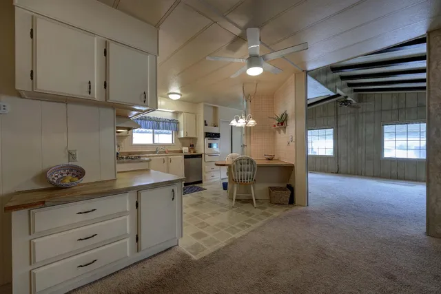 a open kitchen with white cabinets and a dishwasher