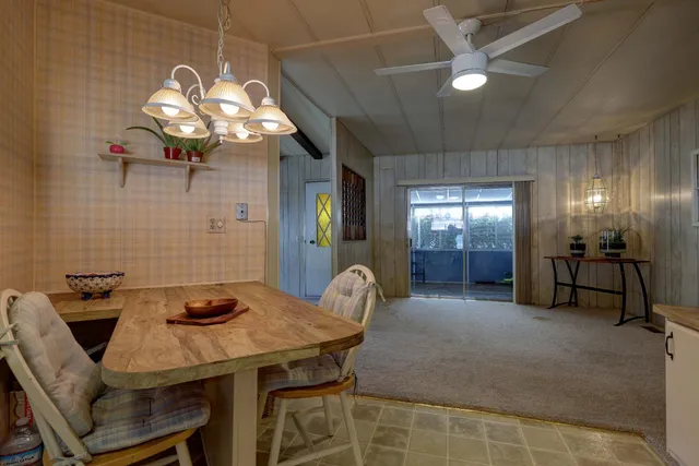 a dining room with furniture and chandelier