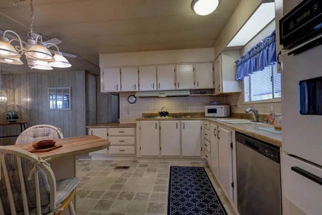 a kitchen with a sink cabinets and window