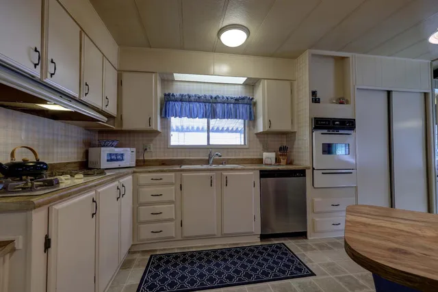 a kitchen with a refrigerator and a sink