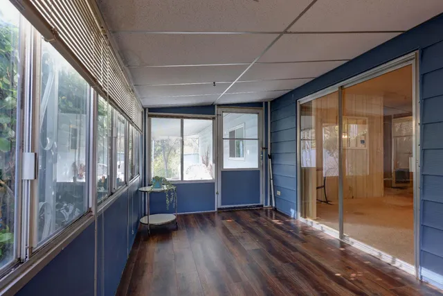 a view of an entryway with wooden floor
