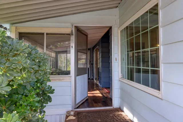a view of house with porch and furniture