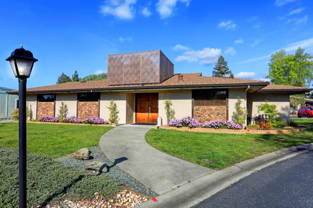 a front view of a house with garden