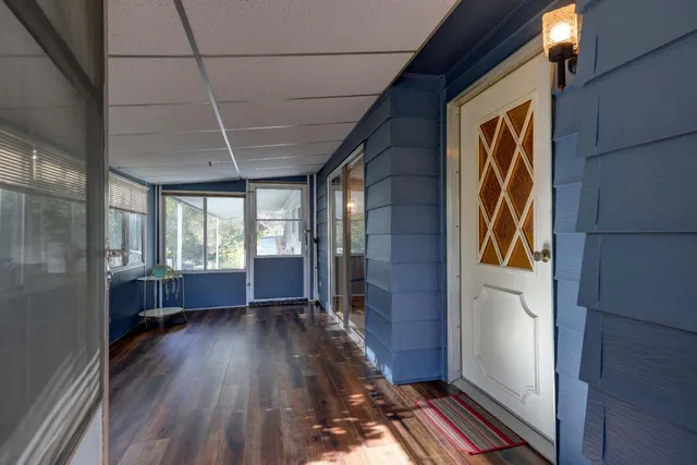 a view of hallway with wooden floor