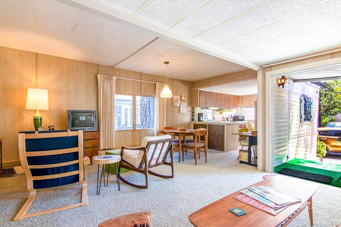 52901 Pine Cove Road, Unit 5 Idyllwild, CA 92549 - Photo 12 of 35 a living room with furniture a dining table and a fireplace