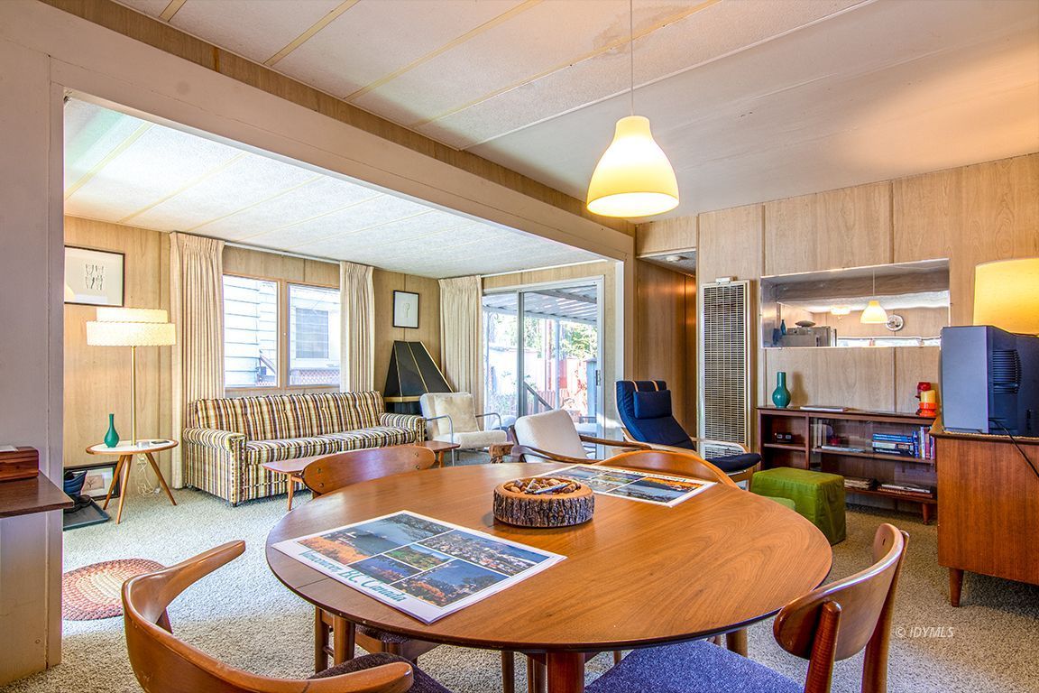 52901 Pine Cove Road, Unit 5 Idyllwild, CA 92549 - Photo 14 of 35 a living room with furniture a rug and a chandelier